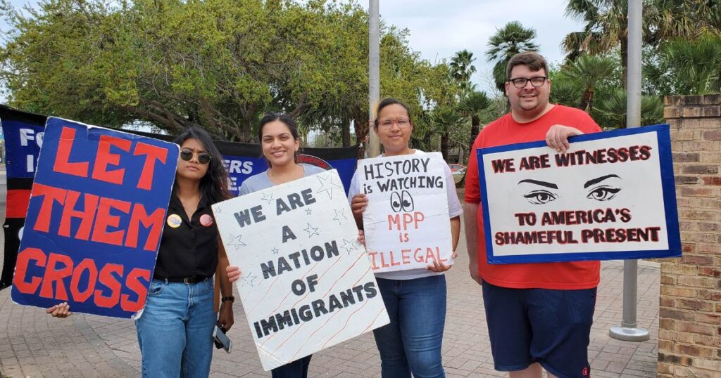 ABFI Student at the US Mexican border carrying signs pro immigrants